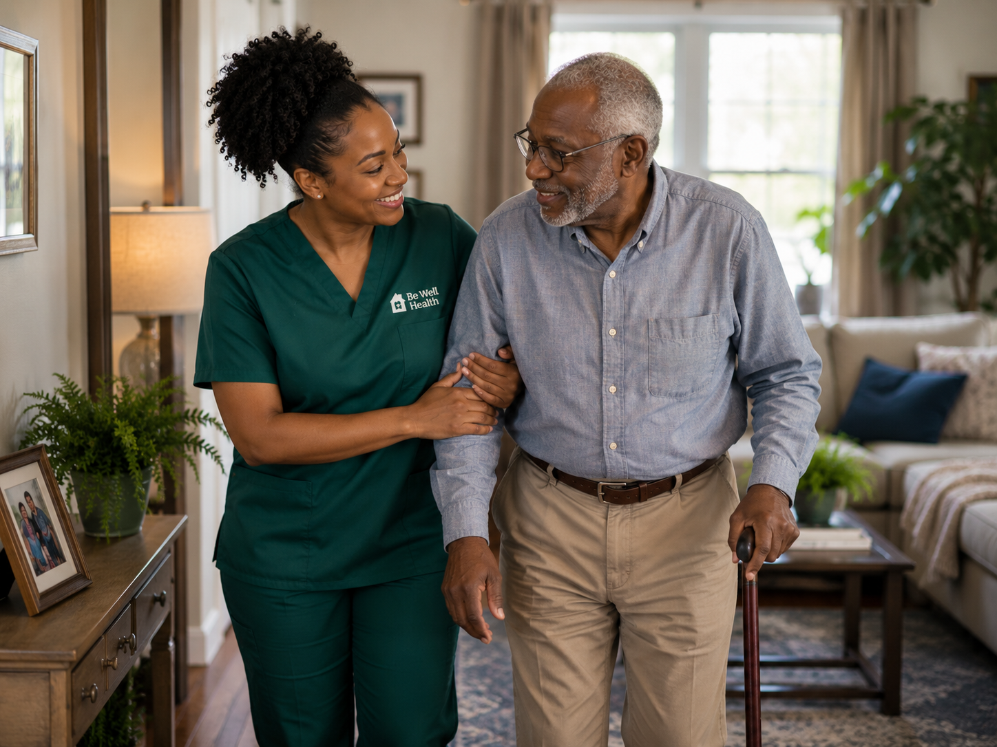 A Be Well caregiver helping an elderly client at home